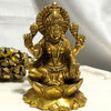 Gold-colored statue of a deity on a white background