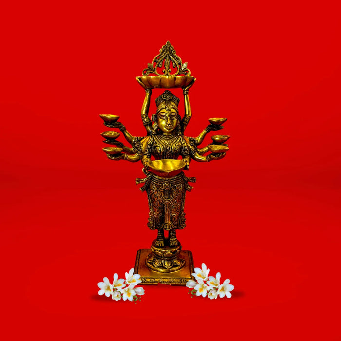 Bronze statue of a deity with multiple arms on a red background