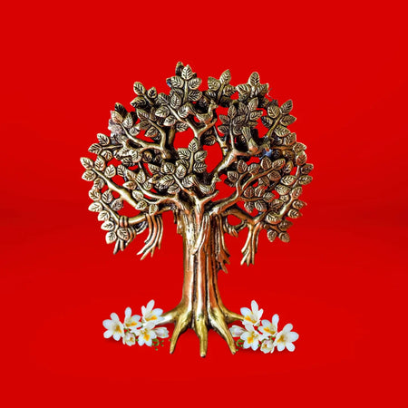 Bronze tree sculpture with white flowers on a red background