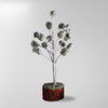 Decorative silver tree branch with a brown base on a light gray background