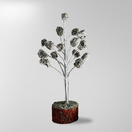 Decorative silver tree branch with a brown base on a light gray background